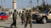 Afghanistan's National Army soldiers stand guard, blocking the main road to the Bagram Airfield's main gate in Bagram, north of Kabul, Afghanistan, Nov. 12, 2016.