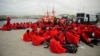 Would-be immigrants rest at Tarifa's harbor after being rescued off the Spanish Coast, Aug. 11, 2014.