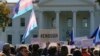 FILE - Members of the Human Rights Campaign and other LGBTQ activists gather on Pennsylvania Avenue in front of the White House in Washington, Oct. 22, 2018.
