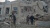 Afghan security forces and NATO troops investigate at the site of an explosion near the German consulate office in Mazar-i-Sharif, Afghanistan, Nov. 11, 2016.