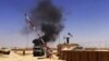 This image posted on a militant news Twitter account on June 12, 2014 shows militants from the al-Qaida-inspired Islamic State, formerly known as the Islamic State in Iraq and the Levant (ISIL), raising their flag at an army base in Ninevah Province, Iraq.
