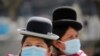 Aymara indigenous women wearing protective masks are seen at the Plaza Murillo during a celebration marking the 195th anniversary of Bolivia foundation at the presidential palace, amid the COVID-19 outbreak, in La Paz, Bolivia, Aug. 6, 2020.