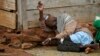 An internally displaced Muslim man lies in front of a house in the town of Boda, Central African Republic, April 15, 2014.