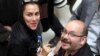 FILE - Jason Rezaian, an Iranian-American correspondent for The Washington Post, and his wife Yeganeh Salehi, an Iranian correspondent for Abu Dhabi-based newspaper The National, attend a presidential campaign of President Hassan Rouhani in Tehran, April 11, 2013. 