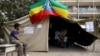 A boy sits outside a polling station, as Ethiopia's national election kicks off in capital Addis Ababa, May 24, 2015. 