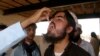 A man, who fled the military offensive against the Pakistani militants in North Waziristan, receives polio vaccination drops upon his arrival in Bannu in Khyber-Pakhtunkhwa province, Pakistan, June 22, 2014.