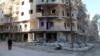 A man walks past damaged buildings in the rebel held besieged al-Sukkari neighbourhood of Aleppo, Syria, Oct. 19, 2016.