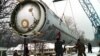 Soldiers prepare to destroy a ballistic SS-19 missile in the yard of the largest former Soviet military rocket base in Vakulenchuk, Ukraine, December 24, 1997. 
