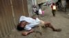 A man sleeps on the streets after drinking distilled traditional alcoholic liquor, locally known as "chang'aa", in the suburbs of Nairobi May 9, 2014