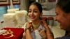 Girl tries on gold necklace inside a jewelry showroom in Mumbai, April 16, 2013.