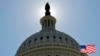 FILE - The U.S. flag flies next to the Capitol in Washington, July 14, 2011. The House of Representatives is to vote shortly on new sanctions against Russia for its meddling in last year's presidential election.