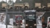 FILE - American military vehicles are transported by train across a bridge in Zagan, Poland, Jan. 12, 2017. 