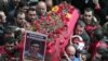 People carry the coffin of Berkin Elvan, a Turkish teenager who was in a coma since being hit on the head by a tear gas canister fired by police during anti-government protests in the summer of 2013, during his funeral in Istanbul, Turkey, March 12, 2014