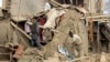 FILE - Afghan villagers gather their properties a day after clashes between Taliban and Afghan security forces in Taliban-controlled Buz-e Kandahari village in Kunduz province, Afghanistan, Friday, Nov. 4, 2016. 