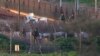 FILE - Israeli soldiers work on a military vehicle that was hit by a missile fired by Hezbollah on the Israel-Lebanon border, Jan. 28, 2015.