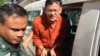 Ny Chakrya, National Election Committee officer, escorted by the security officers at the appeal court, Phnom Penh, Cambodia, November 28, 2016. (Photo: Kann Vicheika/VOA Khmer)