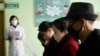 FILE - People review information explaining the COVID-19 coronavirus at the Phyongchon District People's Hospital in Pyongyang, North Korea, April, 1, 2020.