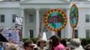 FILE-Protesters carry signs during the People's Climate March at the White House in Washington, April 29, 2017. 