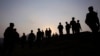 FILE - Pakistan army soldiers gather at a forward area post on the Line of Control (LOC) that divides Kashmir between Pakistan and India, in Tatta Pani, some 200 km from Islamabad, Pakistan, Oct. 1, 2016. On Monday, Pakistan's army claimed ongoing clashes with India killed at least four Pakistani civilians and wounded 10 others.