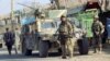 Afghan security forces keep watch in front of their armoured vehicle in Kunduz city, Afghanistan, Oct. 4, 2016. 