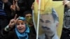 A person holds a poster of jailed Kurdish rebel leader Abdullah Ocalan as Kurdish demonstrators march in Istanbul, Turkey, April 19, 2011. 