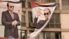 A man peers out of a window under a giant banner supporting Egyptian President Abdel Fattah el-Sissi during a march in Cairo, Egypt, Oct. 2, 2023. Egypt will hold a presidential election over three days in December, with el-Sissi likely to prolong his stay in power until 2030. 