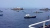 In this photo provided by the Philippine Coast Guard, fishing boats carrying a nongovernment coalition called Atin Ito, Tagalog for This is Ours, pass by waters off Palauig Point, Zambales province, northwestern Philippines as they head toward Scarborough Shoal on May 15, 2024.
