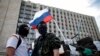 Masked pro-Russia protesters stand guard near a barricade outside a regional government building in Donetsk, in eastern Ukraine, April 23, 2014.
