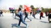 Members of a splinter faction of the Unified Communist Party of Nepal Maoist run and shout slogans as they protest against the formation of an interim government in Katmandu, Nepal, March 14, 2013.