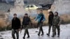 This photo released by the Syrian official news agency SANA, shows Syrian troops and pro-government gunmen marching through the streets of east Aleppo, Syria, Dec. 13, 2016. 
