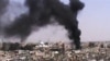 Hoto da ke nuna hayaki yana tashi daga kan wani gini a Homs na Syria.