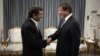 Turkey's Foreign Minister Ahmet Davutoglu (R) shakes hands with Iranian President Mahmoud Ahmadinejad before an official meeting in Tehran, January 5, 2012. 