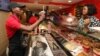 FILE - Customers buy Cold Stone ice cream in Lagos, Nigeria, Feb. 10, 2013. Years of solid economic growth, gradual economic reforms and energy discoveries have transformed Africa from a basket case into one of the world’s hottest markets. 