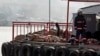 A rescue worker walks past bodies retrieved from the sea after a boat sank in the Bosphorus strait, near Istanbul, November 3, 2014. 