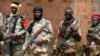 FILE - Seleka fighters warily eye a photographer at their base in Bambari, Central African Republic, May 2014. 
