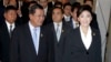 Cambodia's Prime Minister Hun Sen, left, walks with his Thai counterpart Yingluck Shinawatra as they attend ASEAN-UN Summit in Nusa Dua, Bali, Indonesia, file photo. 