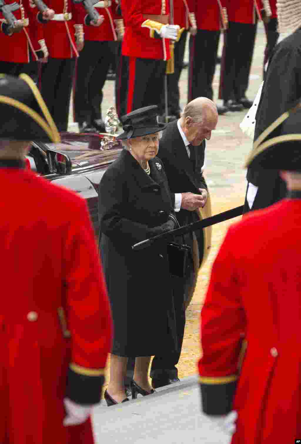 Britain's Queen Elizabeth II, center left, and her husband Prince Philip, the Duke of Edinburgh, arrive for the funeral of former British Prime Minister Margaret Thatcher, outside St. Paul's Cathedral, central London, Wednesday, April 17, 2013.