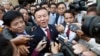 Cambodia's main opposition Cambodia National Rescue Party Deputy President and National Assembly Deputy President Kem Sokha, center, speaks to reporters outside the Phnom Penh Municipality Court in Phnom Penh, Cambodia, Wednesday, April 8, 2015. Sokha appeared at the court on Wednesday to honor his summons to answer questions about the party's protests in 2013 and 2014 against the election results. (AP Photo/Heng Sinith)