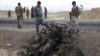 Afghan security forces gather at the site of Monday's suicide attack near the Bagram Air Base, north of Kabul, Afghanistan, April 9, 2019. 