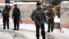 Security personnel stand guard at the site of a suicide attack on the Supreme Court in Kabul, Afghanistan, Feb. 7, 2017. 