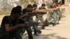FILE - Rebel fighters perform a military display as part of a graduating ceremony at a camp in eastern al-Ghouta, near Damascus, Aug. 31, 2014.