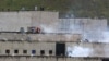 FILE - Tear gas rises from parts of the Turi prison where an inmate riot had broken out in Cuenca, Ecuador, Feb. 23, 2021. Inmates at Turi are holding more than 50 people hostage, the country's interior minister said Aug. 31, 2023, in a protest over prisoner transfers.