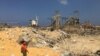 A man walks near rubble at the site of Tuesday's blast, at Beirut's port area, Lebanon, Aug. 7, 2020. 