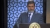 Egypt's President-elect Mohamed Morsi speaks during his first televised address to the nation at the Egyptian Television headquarters, Cairo June 24, 2012.