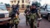 Fighters for the Seleka rebel alliance stand guard in front of the presidential palace in Bangui, Central African Republic, March 25, 2013. 