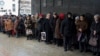 Pensioners stand in a queue to get a financial aid at one of the government offices of the self-proclaimed Donetsk People's Republic in Donetsk, eastern Ukraine, Dec. 12, 2014. 