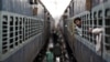A passenger looks through the window of a stalled train as he waits for electricity to be restored at a railway station in New Delhi, India, July 31, 2012. 