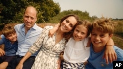 This photo provided by Kensington Palace on Sept. 9, 2024, shows Catherine, Princess of Wales, and Prince William with their children Prince George, right, Princess Charlotte and Prince Louis, left. (Will Warr/Kensington Palace via AP)