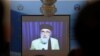 FILE - A screen shows the broadcast of Gulbuddin Hekmatyar during a signing ceremony with Afghan government at the presidential palace in Kabul, Afghanistan, Sept. 29, 2016.