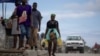 A person carries containers filled with gasoline to sell on the streets in Cap-Haitien, Haiti April 29, 2024.